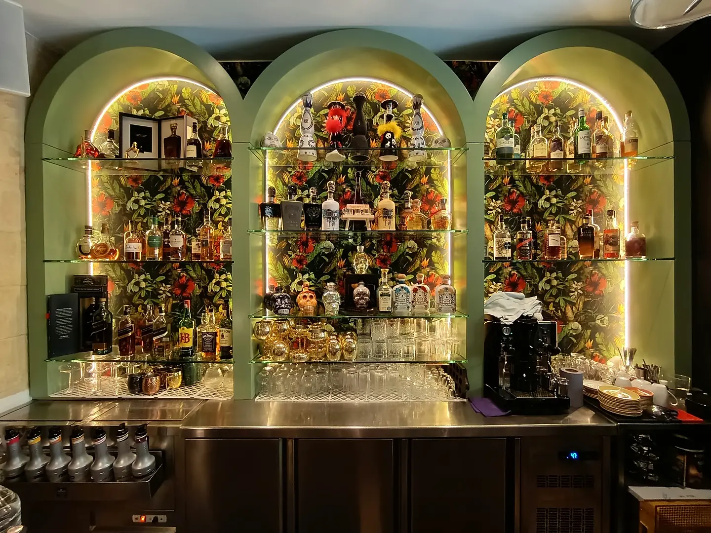Bar with arched display niches and floral arrangements