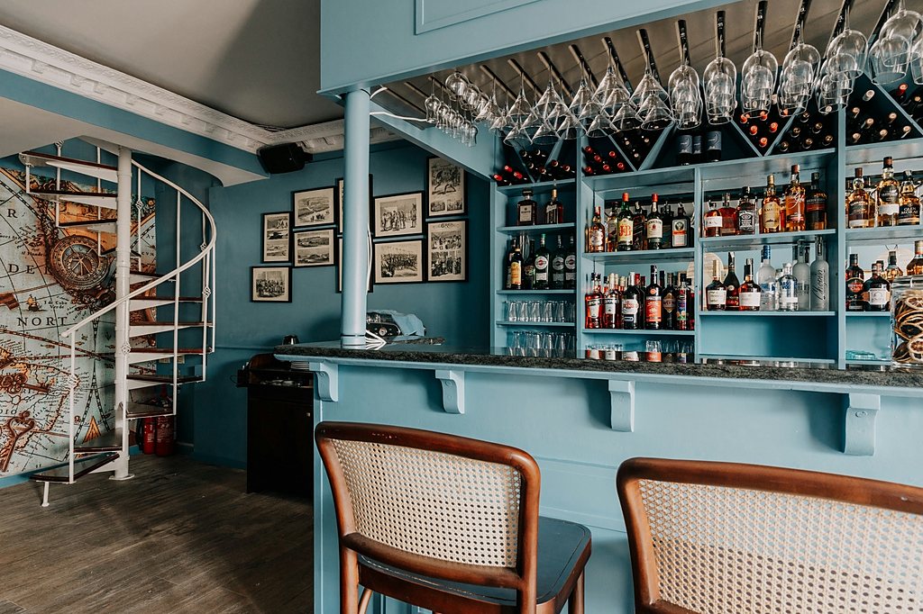 Bar with a wine display wall and bentwood stools
