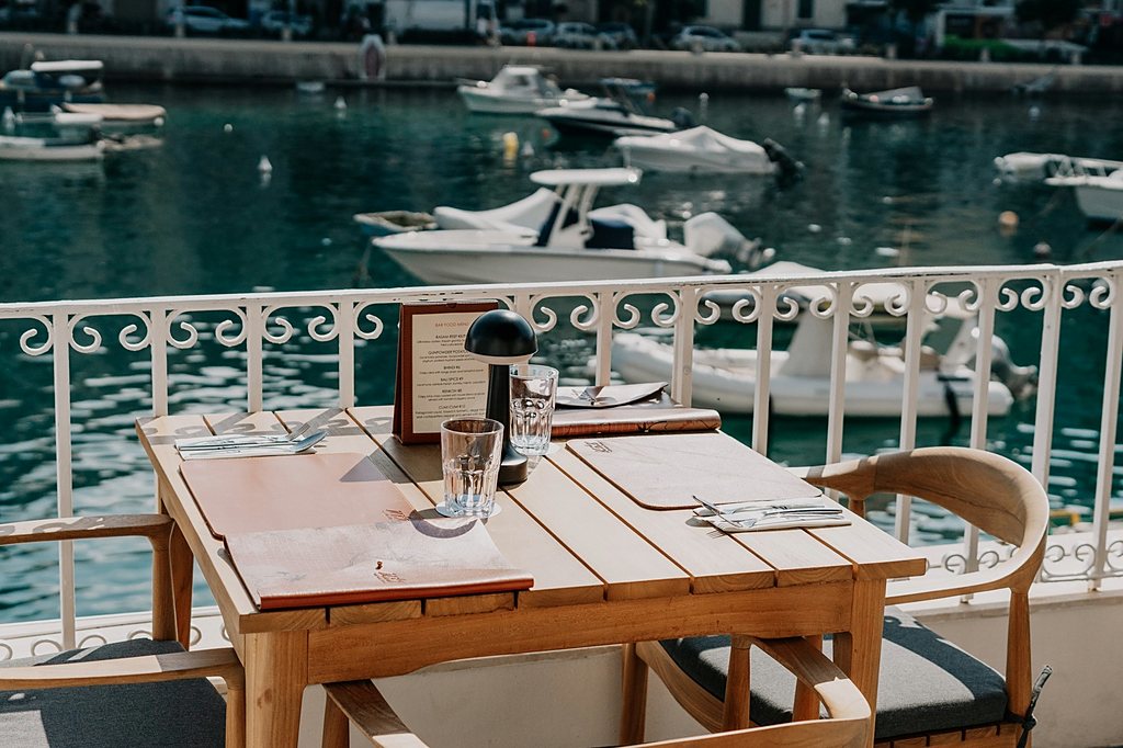 Terrace table setting overlooking a Maltese marina