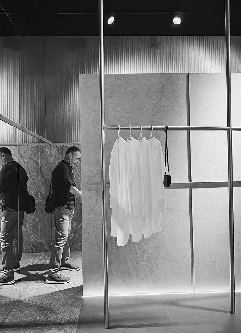 Retail fit-out in book-matched stone, photographed in black and white