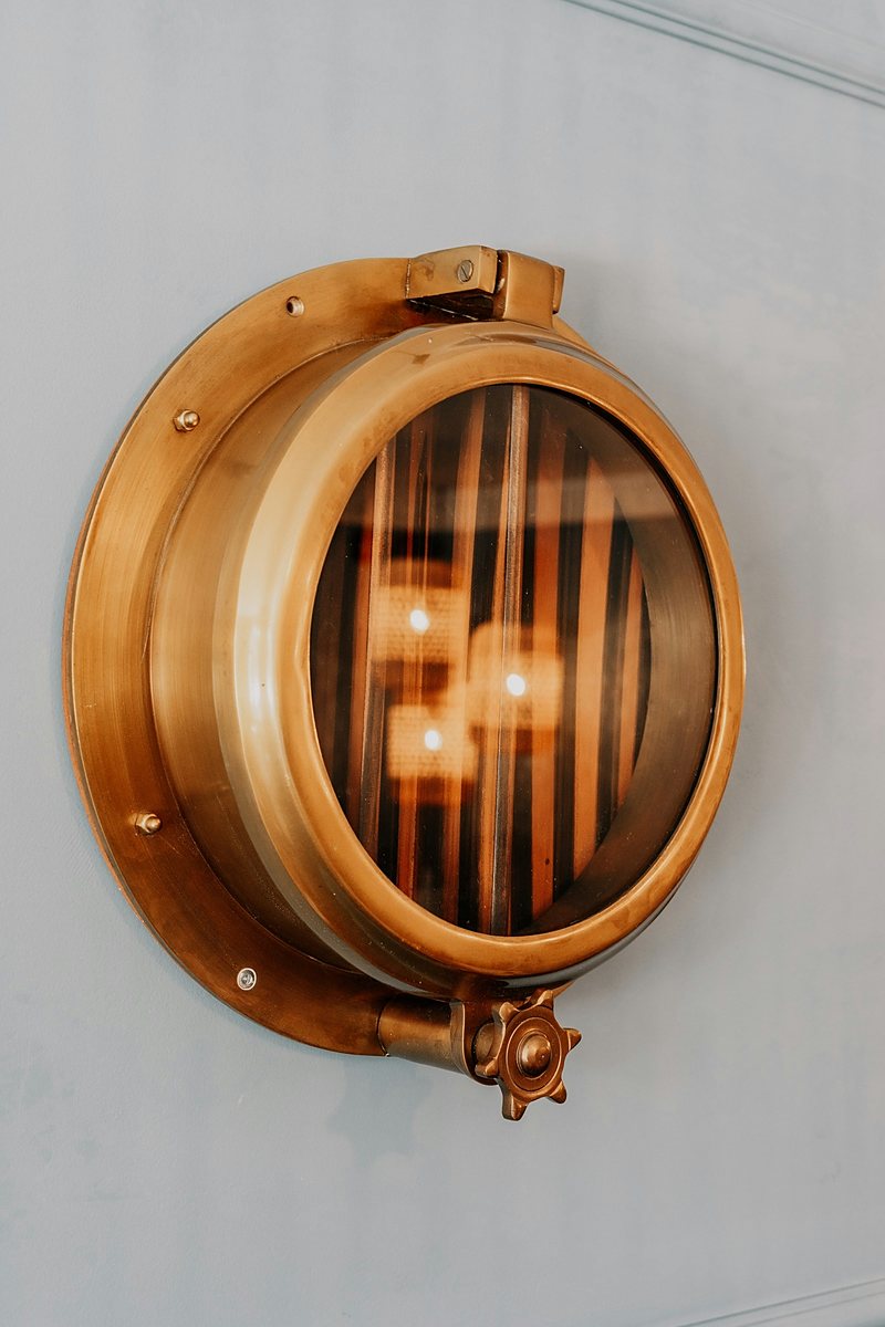 Barrel and porthole wall feature in a bar interior
